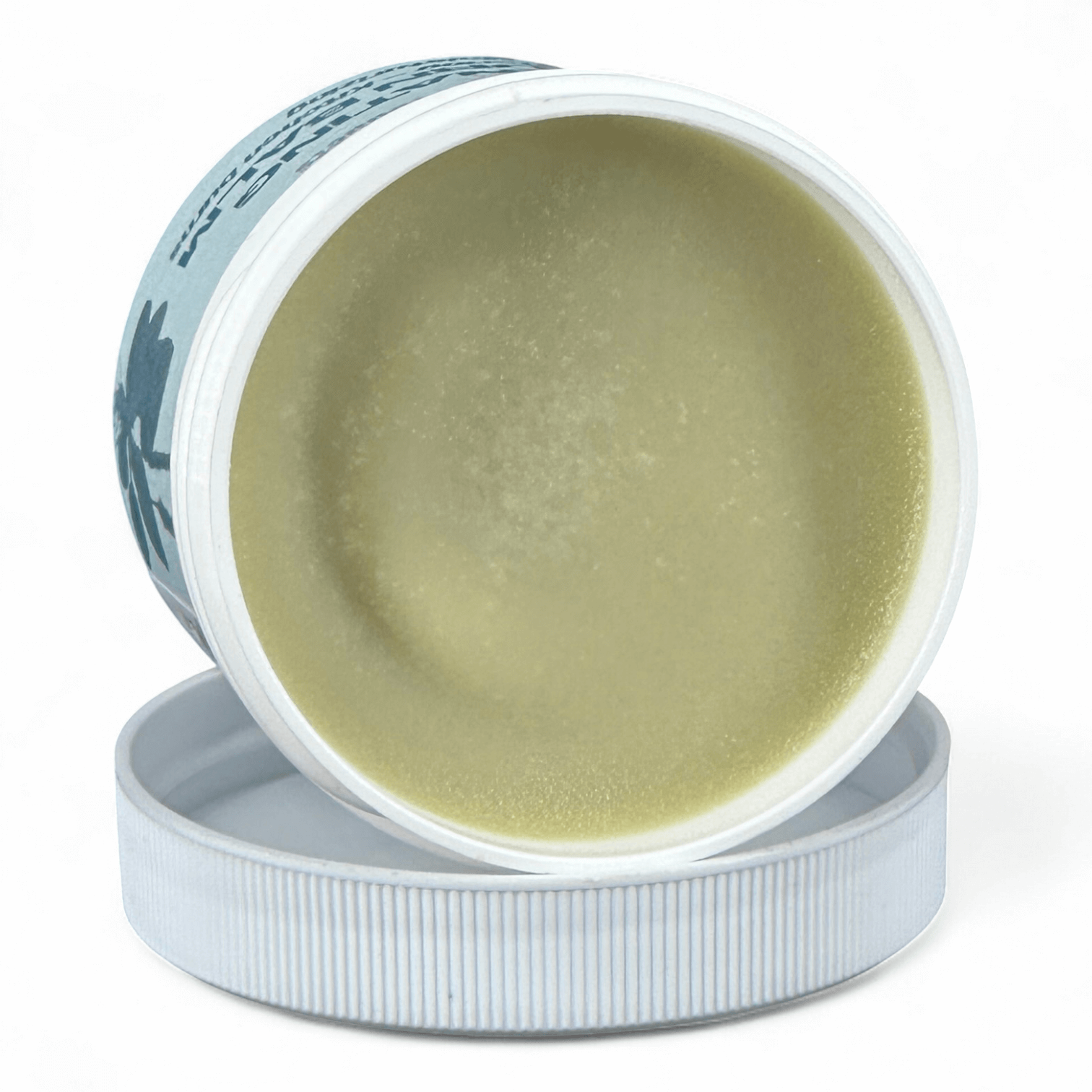Open container of green cream with a white lid on a white background