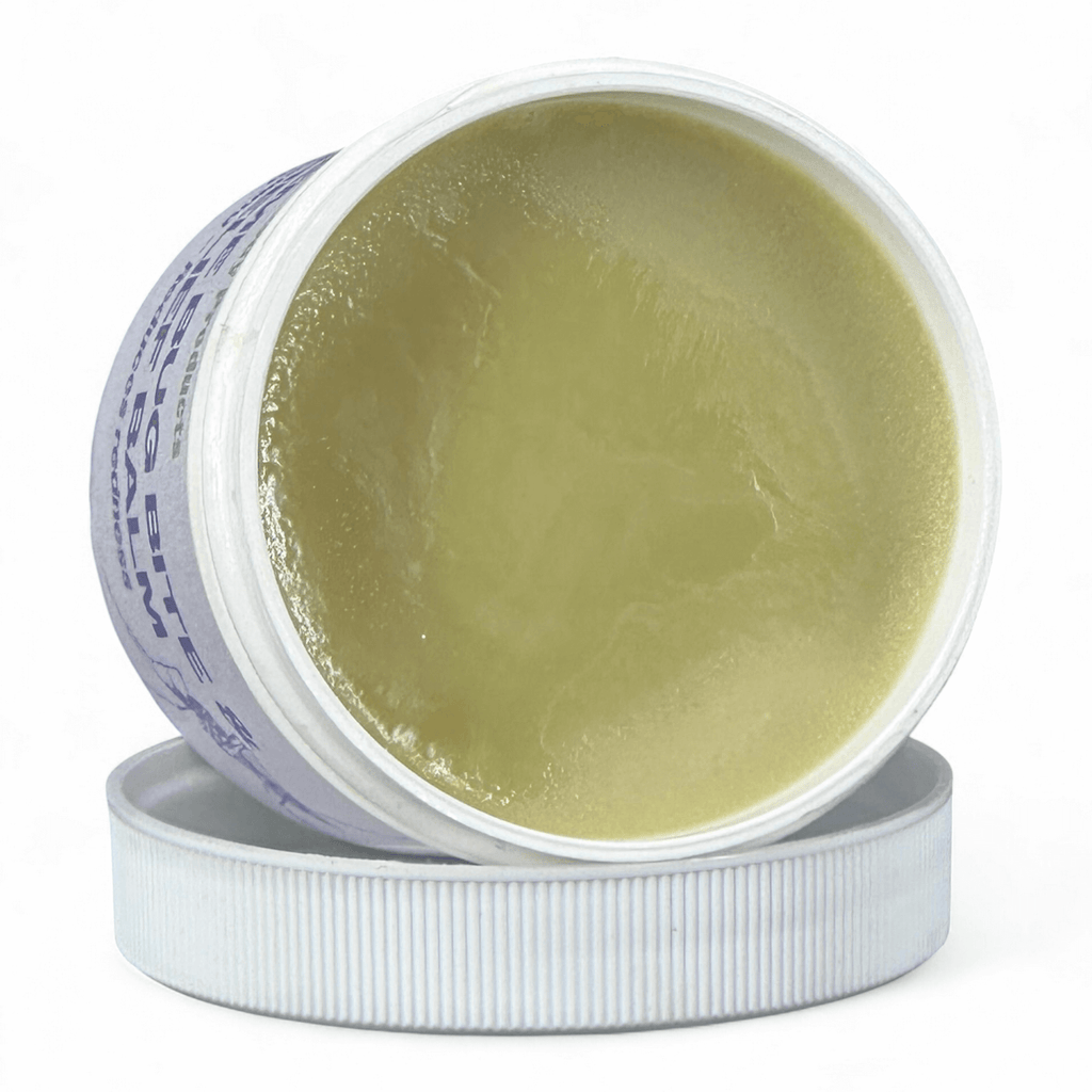 Open jar of green cream with visible label on a white background
