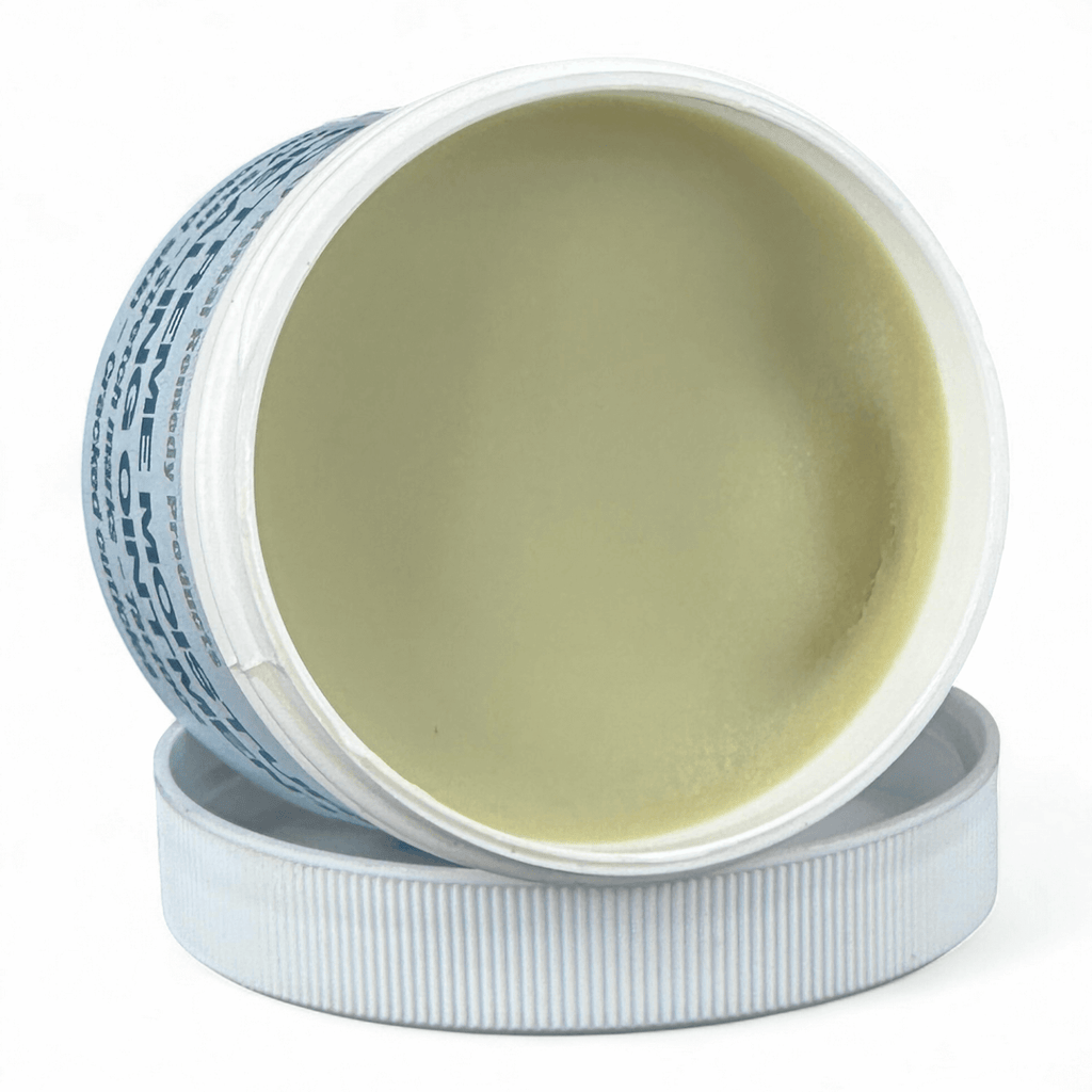 Open jar of cream with visible label on a white background