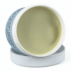 Open jar of cream with visible label on a white background